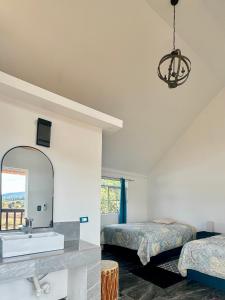 a bathroom with two beds and a sink and a mirror at Valle de Cerocahui Hotel in Cerocahui