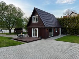a small house with a picnic table in front of it at Ežerų glėby in Zarasai