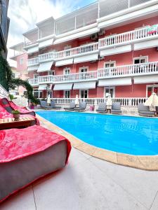 a hotel with a swimming pool in front of a building at Villa Antonis in Parga