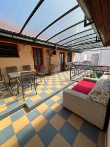 a patio with a couch and a table and chairs at Car-es panzió in Veľký Meder