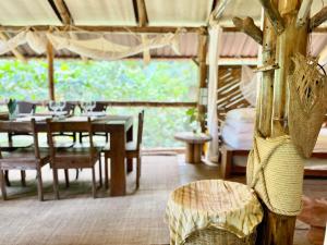 a dining room with a table and chairs in a tent at Ecocabaña Pocahontas en rio Santo Domingo, Melcocho in Cocorná