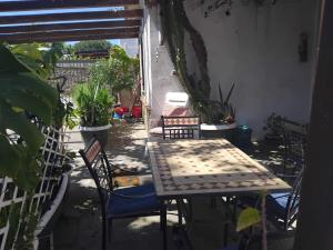 a table and chairs on a patio with plants at La capannina cilento num 11 in San Marco di Castellabate