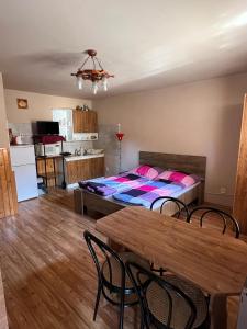 a bedroom with a bed and a table and chairs at Car-es panzió in Veľký Meder