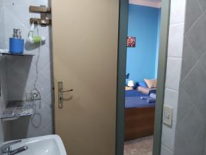 a bathroom with a door leading to a bedroom at La capannina cilento num 11 in San Marco di Castellabate +59 photos