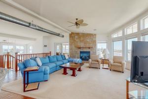 a living room with a blue couch and a fireplace at Town of Fenwick Island --- 23 W Essex St in Fenwick Island