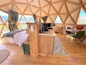 a room with a bed and a table in a yurt at L'étoile du Béarn in Asson