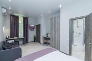 a hotel room with a bedroom and a bathroom at Seven Apart Hotel in Vyshneve