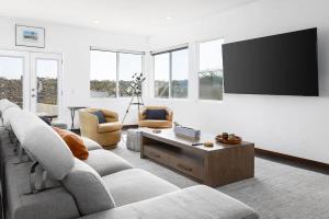a living room with couches and a flat screen tv at Large Home With Sauna in Vista