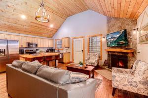 a living room with a couch and a fireplace at Whispering Pines Cabin in Whittier