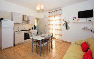 a kitchen and living room with a table and a couch at Cuore Di Casa in Ragusa