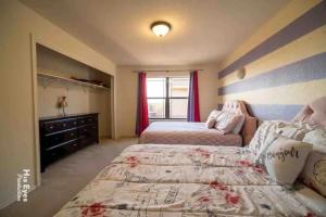 a bedroom with two beds and a dresser at Hill Country Beauty in Red in Cedar Park