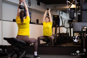 two women exercising in front of a mirror at Infinity Hotel & More in Budva
