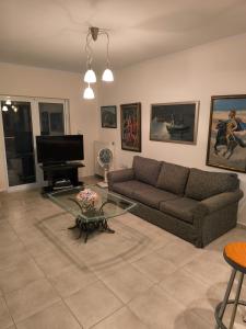 a living room with a couch and a piano at Villa Diapori in Tsimándria