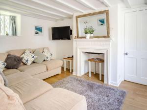 a living room with a couch and a fireplace at Lisle Combe Cottage in Ventnor