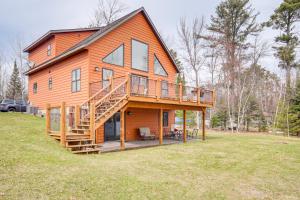 イーグル・リバーにあるBoat Dock and Furnished Deck Northwoods Lake Houseの大きな木造家屋(大きなデッキ付)
