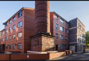 a brick building with a brick pillar in front of it at 2 Beds Mint drive With Secure car Or Van Park w WiFi-Netflix No Deposit Required in Birmingham