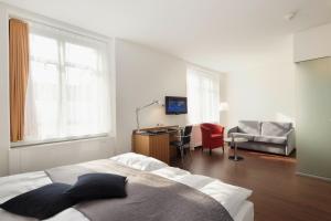 A bed or beds in a room at Sorell Hotel Rütli
