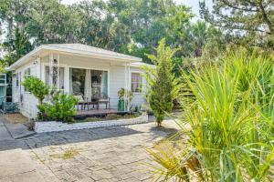 a small white house with a patio at 4 Mi to Daytona Boardwalk and Beaches Cute Cottage in Holly Hill