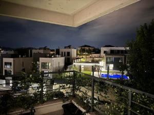 a view of a city at night from a balcony at Luxury Stay surrounded by Nature in Tirana