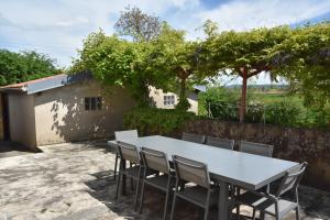 a white table and chairs on a patio at Le Nid des Cigognes avec terrace in Thionville
