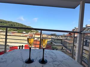 two glasses of wine sitting on a table on a balcony at Villa Antonis in Parga