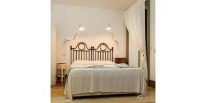 a bedroom with a bed with a white bedspread at La Moresca Hotel in Marina di Ragusa