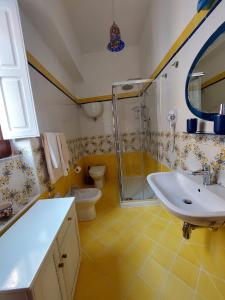 a bathroom with a sink and a shower and a toilet at palazzo sardanelli camera in Pizzo