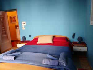 a bed in a blue room with towels on it at La capannina cilento cam 10 in San Marco di Castellabate