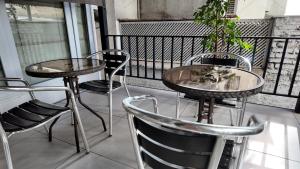 a couple of tables and chairs on a balcony at Chilhotel en Providencia in Santiago
