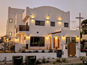 a large white building with lights on it at Rise Suites Oceanside in Oceanside