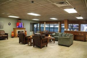a living room with couches and chairs and a fireplace at Dells Vacations At Tamarack Resort in Wisconsin Dells