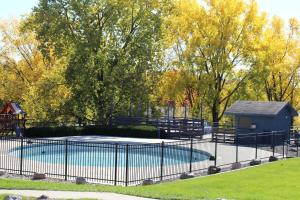 a fence around a swimming pool in a park at Dells Vacations At Tamarack Resort in Wisconsin Dells