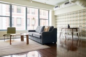 a living room with a couch and a table at Lux 2br in the Heart of FIDI in Boston