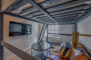 a room with a bed and a table and a tv at Cozy Studio South End in Boston +1 photo