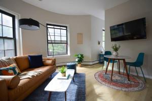 a living room with a couch and a table at Comfy Back Bay Alcove Studio Apt in Boston