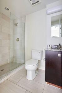 a bathroom with a toilet and a glass shower at Bold and Spacious 2 Bed in Boston Financial District in Boston +10 photos