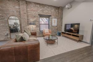 a living room with a couch and a tv at Charming 1 Bedroom Apt Laundry in Unit in Boston