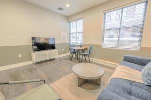 a living room with a couch and a table and a tv at Boston Financial District 1BR Walk to anything in Boston