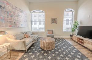 a living room with a couch and a tv at Airy 2BR in Fidi Boston Walk anywhere in Boston
