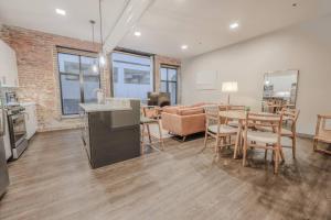 a kitchen and living room with a table and chairs at Elegant 2 Bedroom Prime Location in Boston