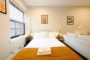 a bedroom with a white bed and a window at Bold and Spacious Studio Back Bay in Boston