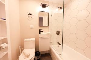 a bathroom with a toilet and a shower at Bold and Spacious Studio Back Bay in Boston