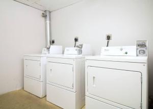a room with white washers and dryers at Studio walking distance to MGH and Tufts Medical in Boston +4 photos