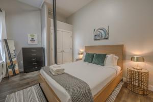 a bedroom with a large bed with a wooden headboard at Unbeatable Location 4 bed Loft Parking Optional in Boston