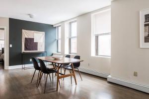 a dining room with a table and chairs at Beautiful 2 Bedroom Financial District Apartment in Boston