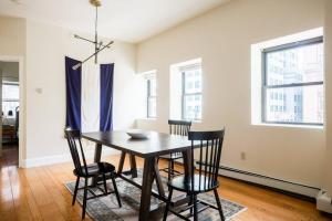 a dining room with a table and four chairs at Fabulous 2bed 2bath apartment downtown Boston in Boston