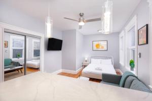 a white room with a bed and a couch at Cozy Central Fenway Studio in Boston