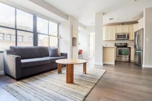 a living room with a couch and a table at Spacious FIDI 2br 2ba Close to Everything in Boston