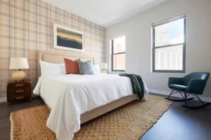 a bedroom with a large bed and a chair at New and Lovely 1br in FIDI District with Keyless Entry in Boston