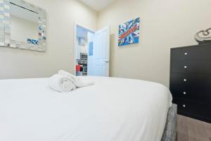 a bedroom with a white bed and a dresser at Simple 1br Financial District Keyless Entry in Boston